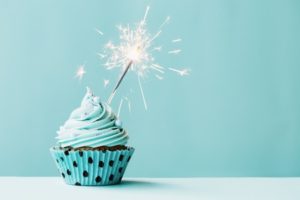 45273894 - cupcake with sparkler against blue